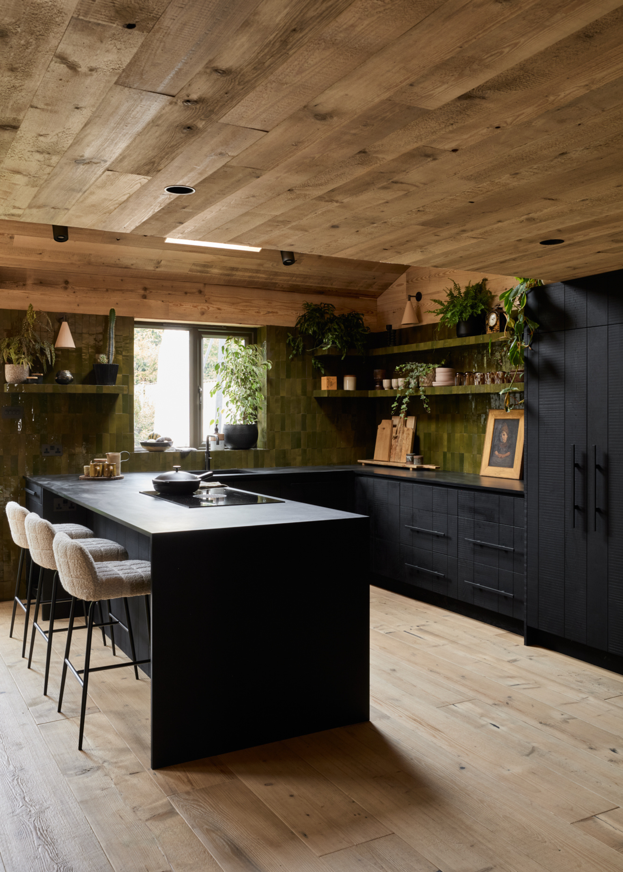 wood drenched kitchen with black cabinets