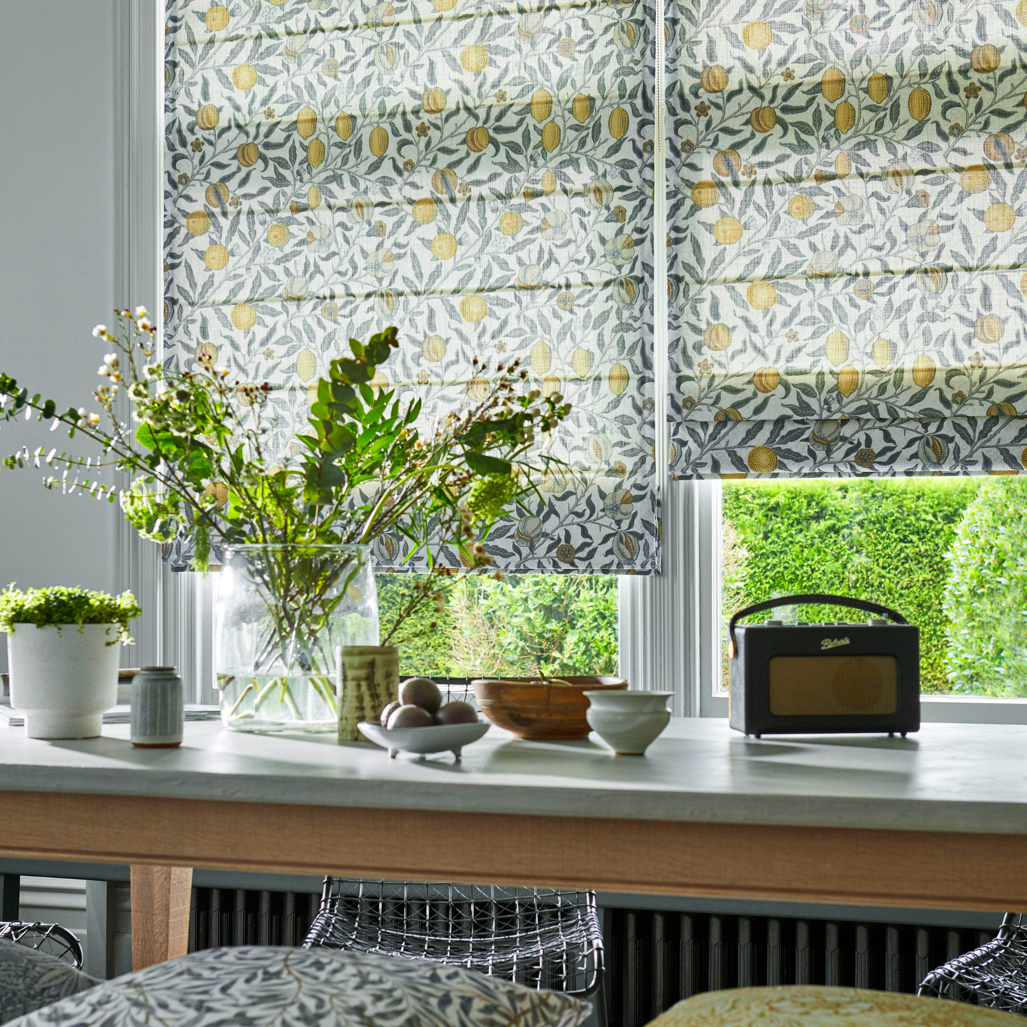 a fruit print roman blind in a kitchen diner