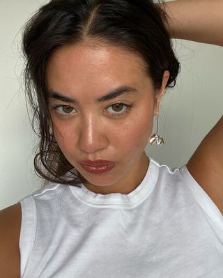 Sasha Mei shows off her dewy, healthy skin paired with a deep, mauve lip