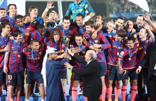 Barcelona players celebrate after beating Estudiantes to win the FIFA Club World Cup in December 2009.