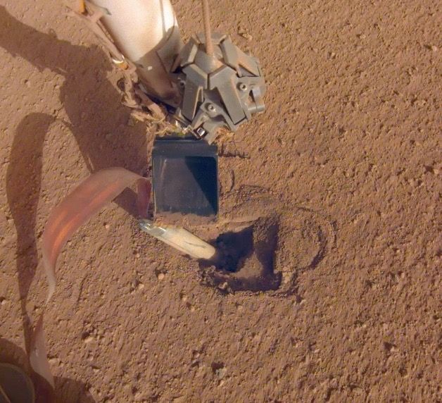 NASA&#039;s Mars InSight lander recently moved its robotic arm closer to its digging device, called the &quot;mole,&quot; in preparation to push on its top, or back cap. Photo released on Feb. 21, 2020.