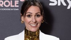 headshot of suranne jones wearing gold and white 