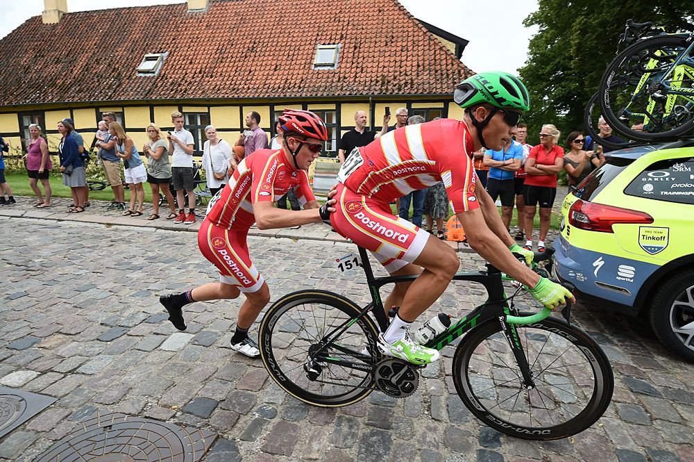 Teammates help each other out during a mechanical