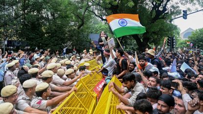 Supporters of India’s Cockroach Janta Party clash with police in New Delhi.