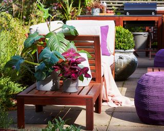 An outdoor patio area with Ikea NYPON plant pot, and table/stool and one-seat wooden sectional from APPLARO range