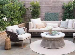 An outdoor space with cushions and throws