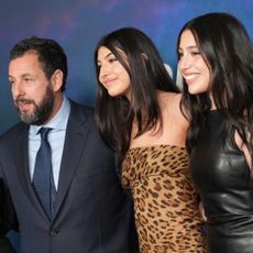 dam Sandler, Sunny Sandler and Sadie Sandler smiling on the red carpet for Netflix's "Spaceman" at The Egyptian Theatre Hollywood on February 26, 2024 in Los Angeles