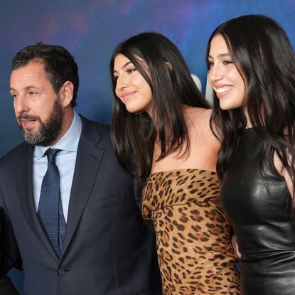 dam Sandler, Sunny Sandler and Sadie Sandler smiling on the red carpet for Netflix's "Spaceman" at The Egyptian Theatre Hollywood on February 26, 2024 in Los Angeles