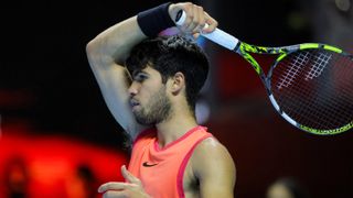 Spain&#039;s Carlos Alcaraz, wearing a red tennis vest, plays a shot ahead of his appearance at the Paris Masters 2024 tournament 