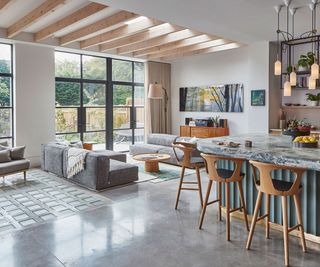 modern open plan kitchen with polished concrete flooring and living area
