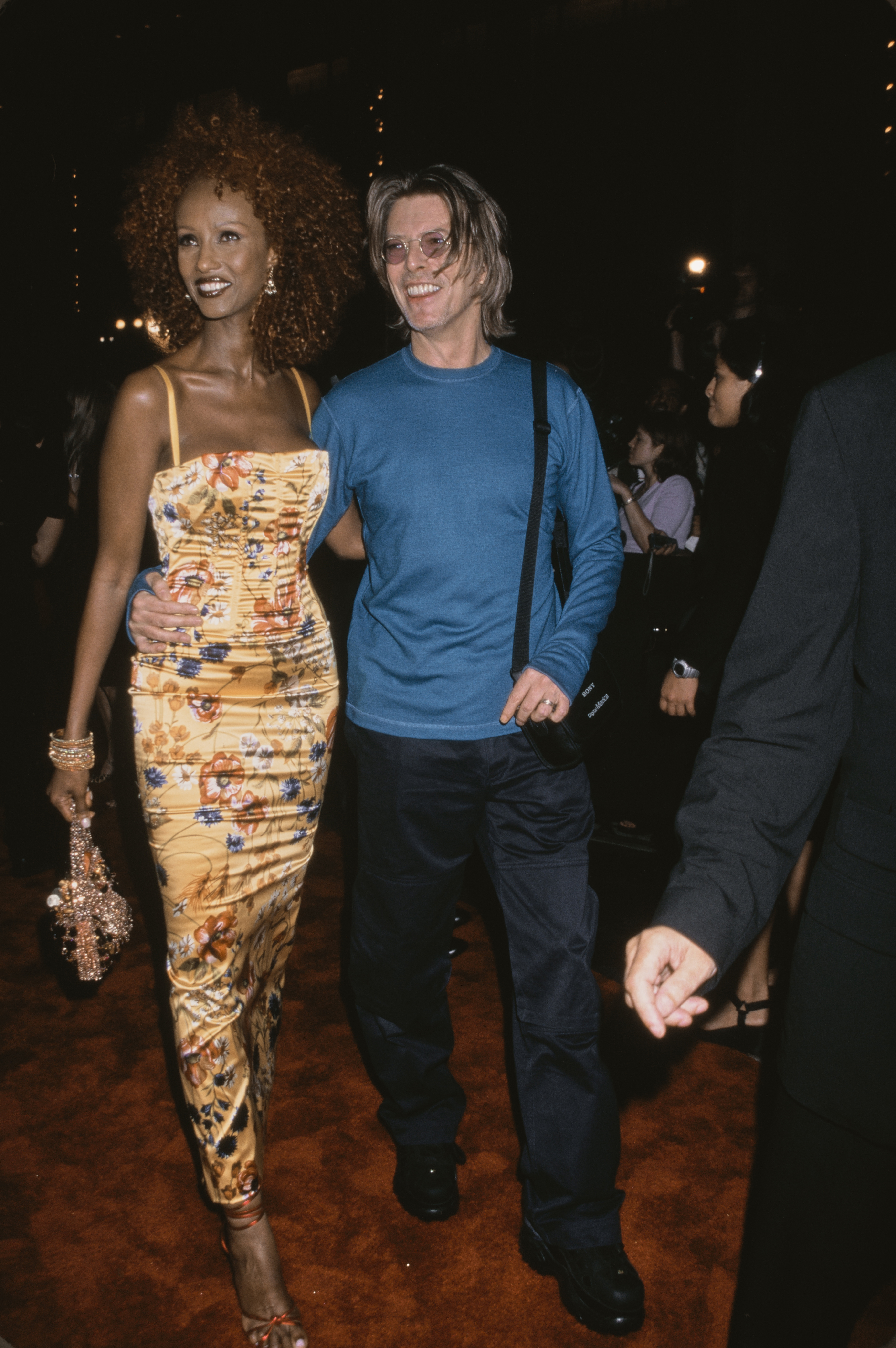 Iman wearing an iconic '90s outfit of a floral print dress.