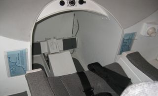A view inside the cockpit of the centrifuge shows the chair where we're strapped in, as well as the
