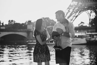 A happy couple goes walking with their baby