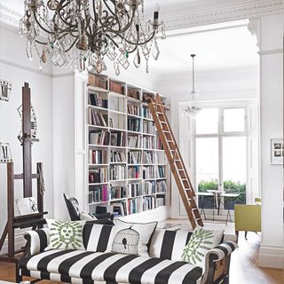 white walls and book shelves with pin-stripe sofa