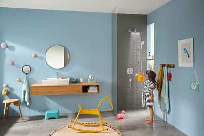 Blue bathroom with wooden floating table with skink, colored circle hooks