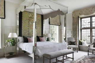 Bedroom with double four poster bed clad in mirrors