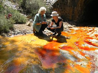 Penny Boston and Cassie Conley sample the acidic waters of Rio Tinto. This river in Spain might hold clues to the possibility for life on Europa.