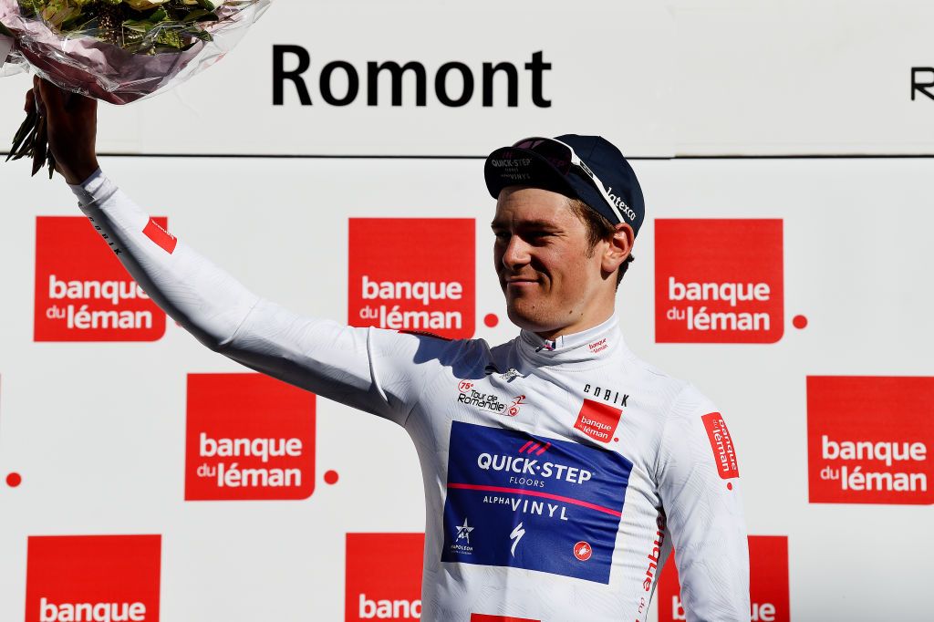 ROMONT SWITZERLAND APRIL 27 Mauro Schmid of Switzerland and Team QuickStep Alpha Vinyl celebrates winning the white best young jersey on the podium ceremony after the 75th Tour De Romandie 2022 Stage 1 a 178km stage from La Grande Beroche to Romont 777m TDR2022 on April 27 2022 in Romont Switzerland Photo by Dario BelingheriGetty Images
