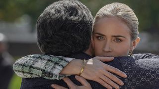 Brian d'Arcy James and Emily Blunt hugging in Pain Hustlers