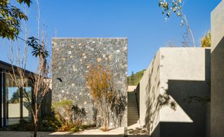 Exterior view with stone wall at Hill house