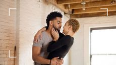 Couple standing up and embracing romantically, looking into each other's eyes, representing the best standing sex positions