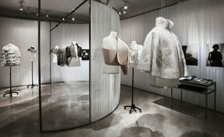Made- to-order couture capes on display