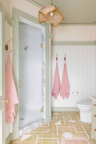 A bathroom with shiplap walls and painted wainscoting
