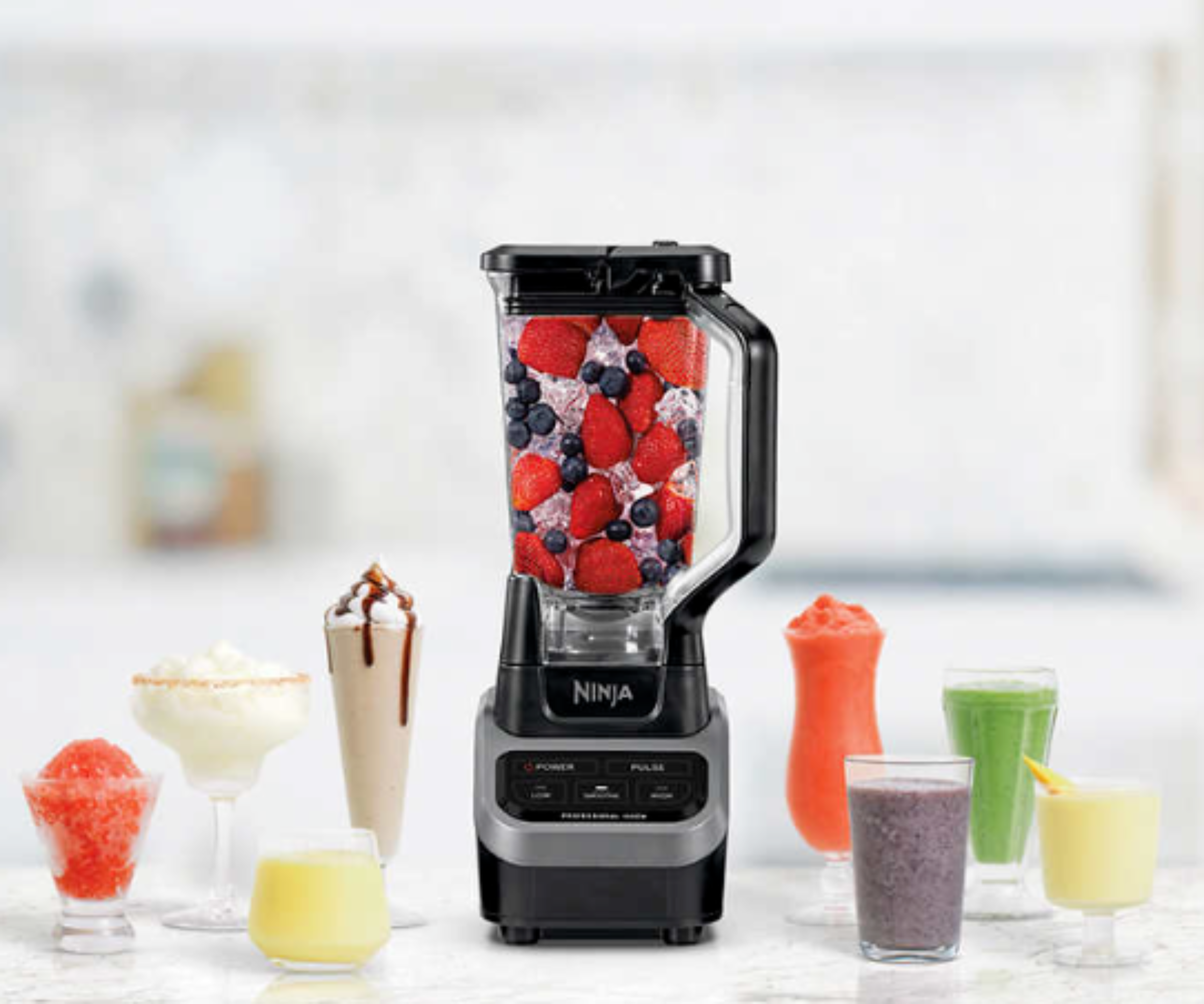 Ninja Foodi blender with auto IQ on a marble countertop surrounded by colorful drinks and coffees