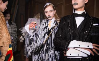 Swatches of houndstooth fabric, cut into brow and lip shapes covered the models’ mouths and eyebrows