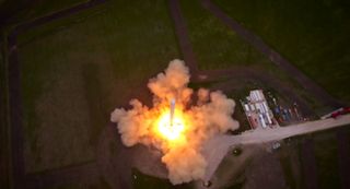 A SpaceX Falcon 9 Reusable rocket prototype fires up its nine Merlin rocket engines for a debut launch and landing test in McGregor, Texas in this aerial view from a drone video released by SpaceX on April 18, 2014.