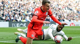 Solly March goes down under a challenge from Japhet Tanganga in Brighton's 2-1 loss to Tottenham in April 2023.