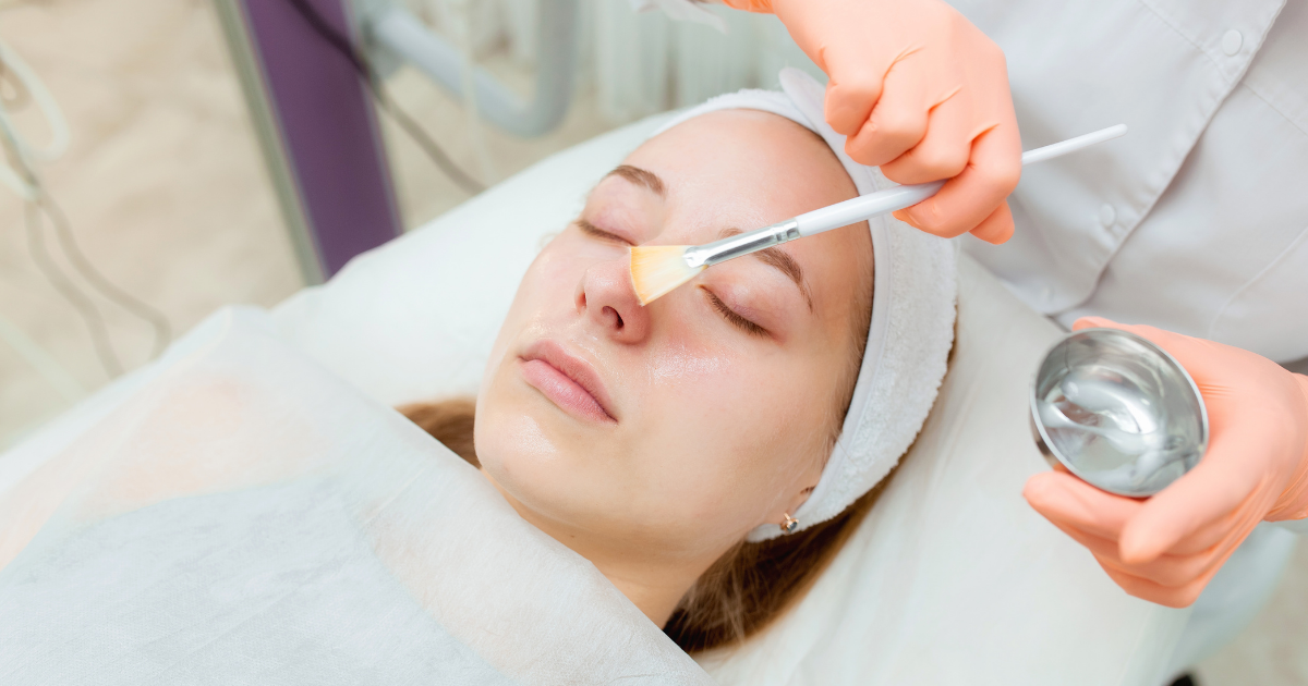 Aesthetician Or Dermatologist Portrait Cosmetologist applying mask on client's face in spa salon. Wellness center. Healthcare occupation - stock photo