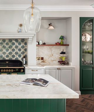 A kitchen with green geometric tile backsplash