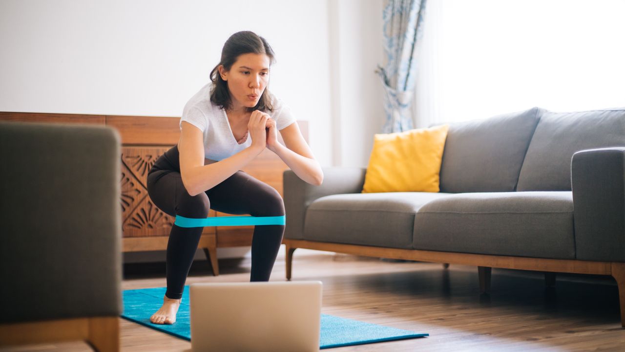 woman doing resistance band workout at home