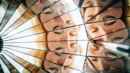 An artist's conception of consciousness, shown as a mirror with many facets reflecting the same face.