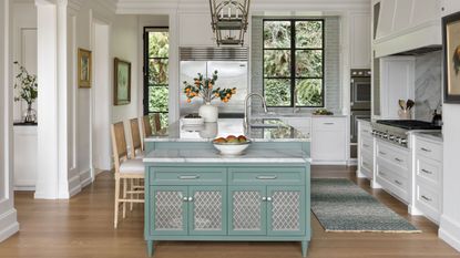 White kitchen with pale green island