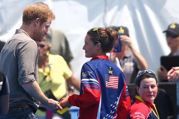 Elizabeth Marks gives her gold medal to Prince Harry.