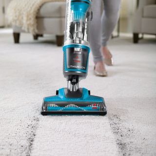 white carpet flooring and vacuum cleaner