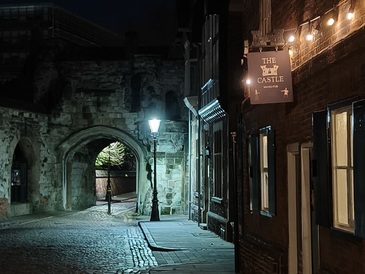 Street at night lit by a lampost