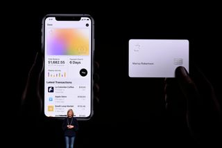 Jennifer Bailey, vice president of Apple Pay, speaking on a dark stage in front of two large graphics showing new features in Apple Pay
