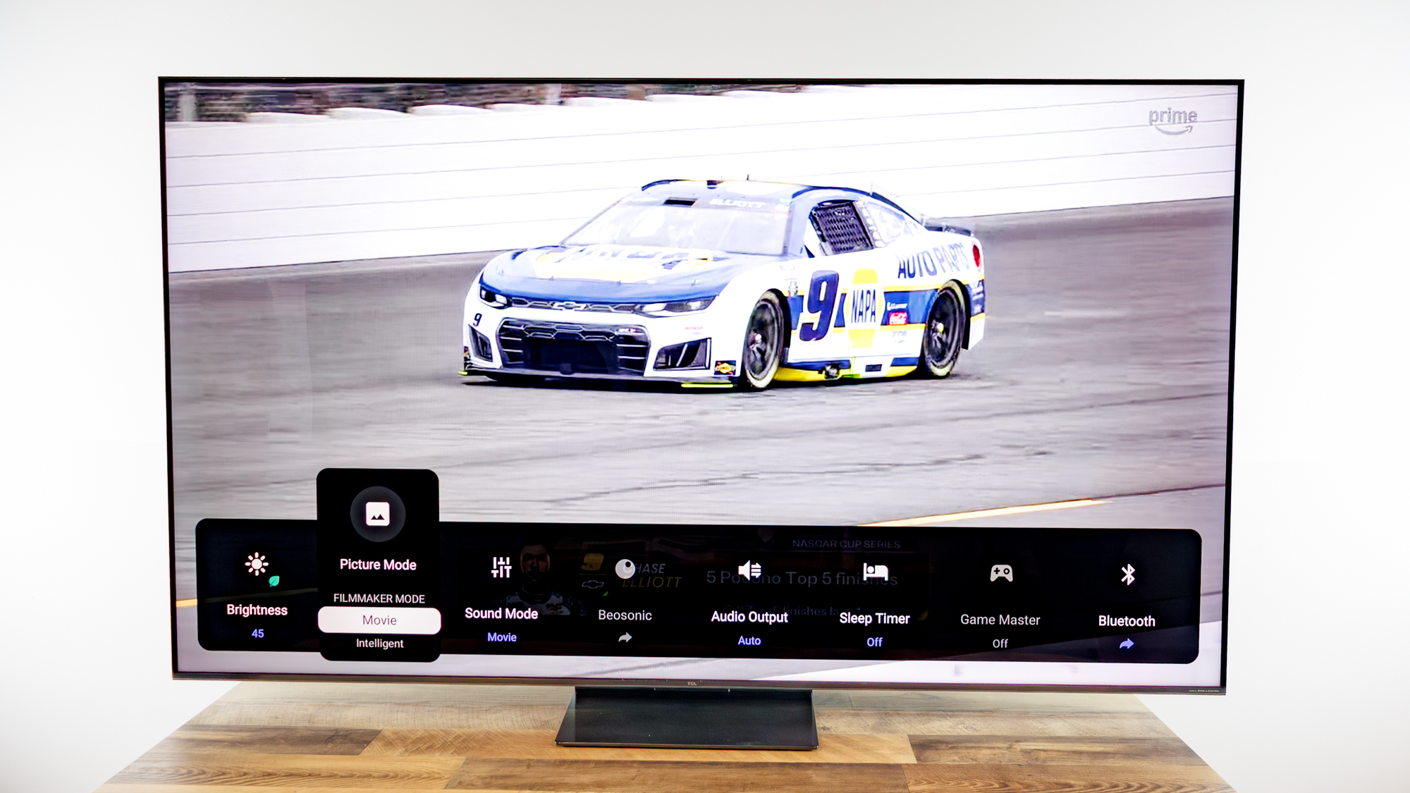 TCL QM7L 75-inch TV on a desk
