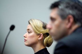 Actress Amber Heard listens in the courtroom at the Fairfax County Circuit Courthouse in Fairfax, Virginia, April 25, 2022. - Actor Johnny Depp sued his ex-wife Amber Heard for libel in Fairfax County Circuit Court after she wrote an op-ed piece in The Washington Post in 2018 referring to herself as a "public figure representing domestic abuse." (Photo by Steve Helber / POOL / AFP) (Photo by STEVE HELBER/POOL/AFP via Getty Images)