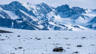 Dark rocks strewn across the ice in Antarctica