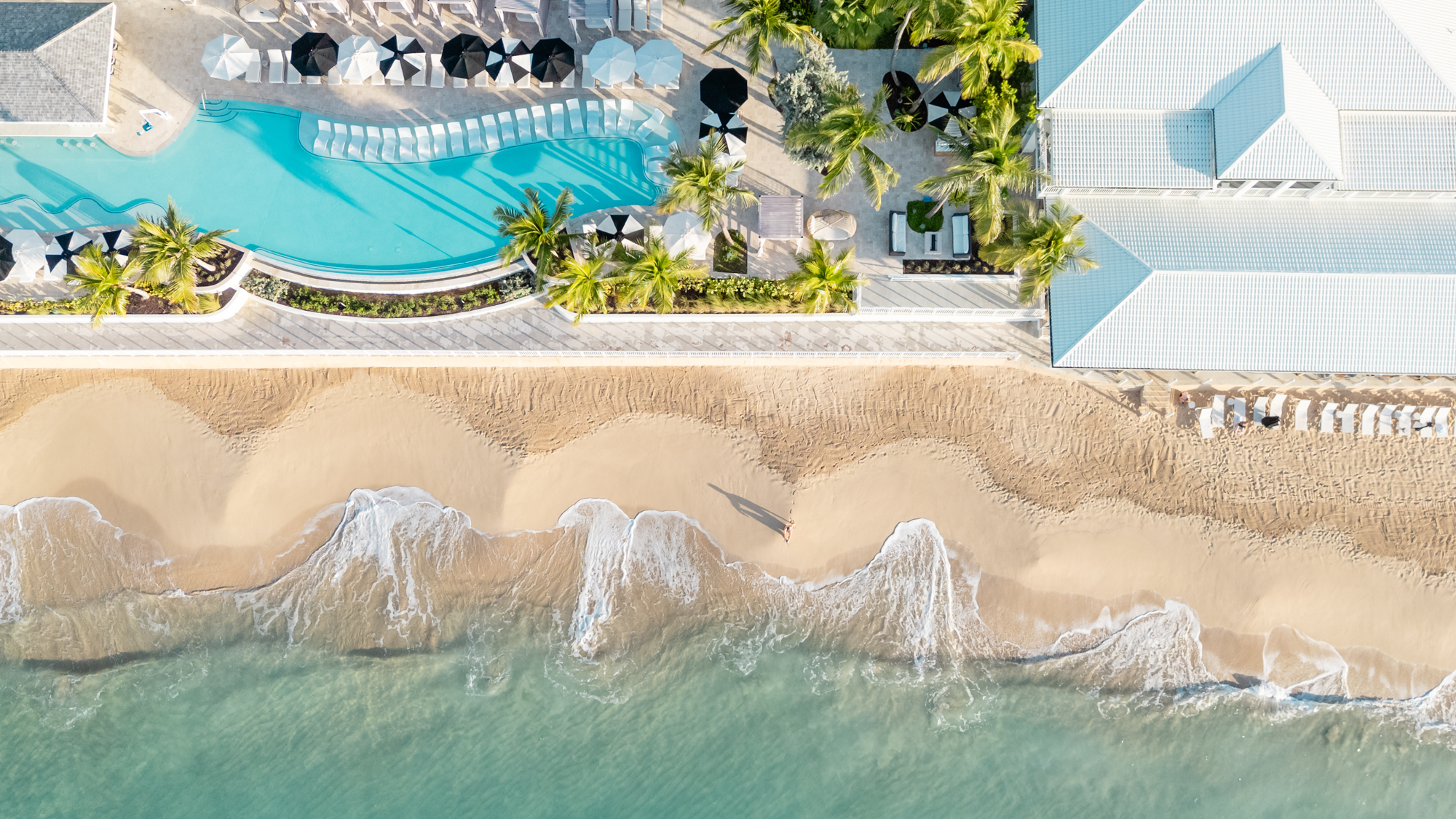 The waves crash on the beach in front of Buoy House Beach Resort