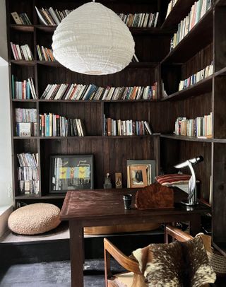 home office with bookcase, desk, chair, white fabric lampshade