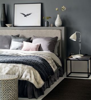 grey bedroom with upholstered bed and shelf