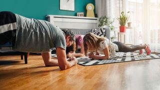 Family doing forearm planks during TV ad breaks