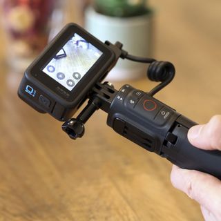 GoPro Volta with a goPro camera attached held in a person's hand