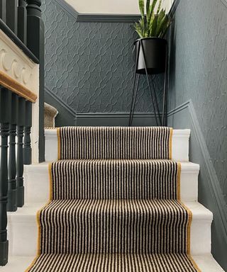 striped carpet on stairs with turn