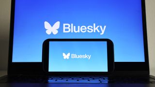 In this photo illustration, the Bluesky logo is displayed on a cell phone and computer monitor.